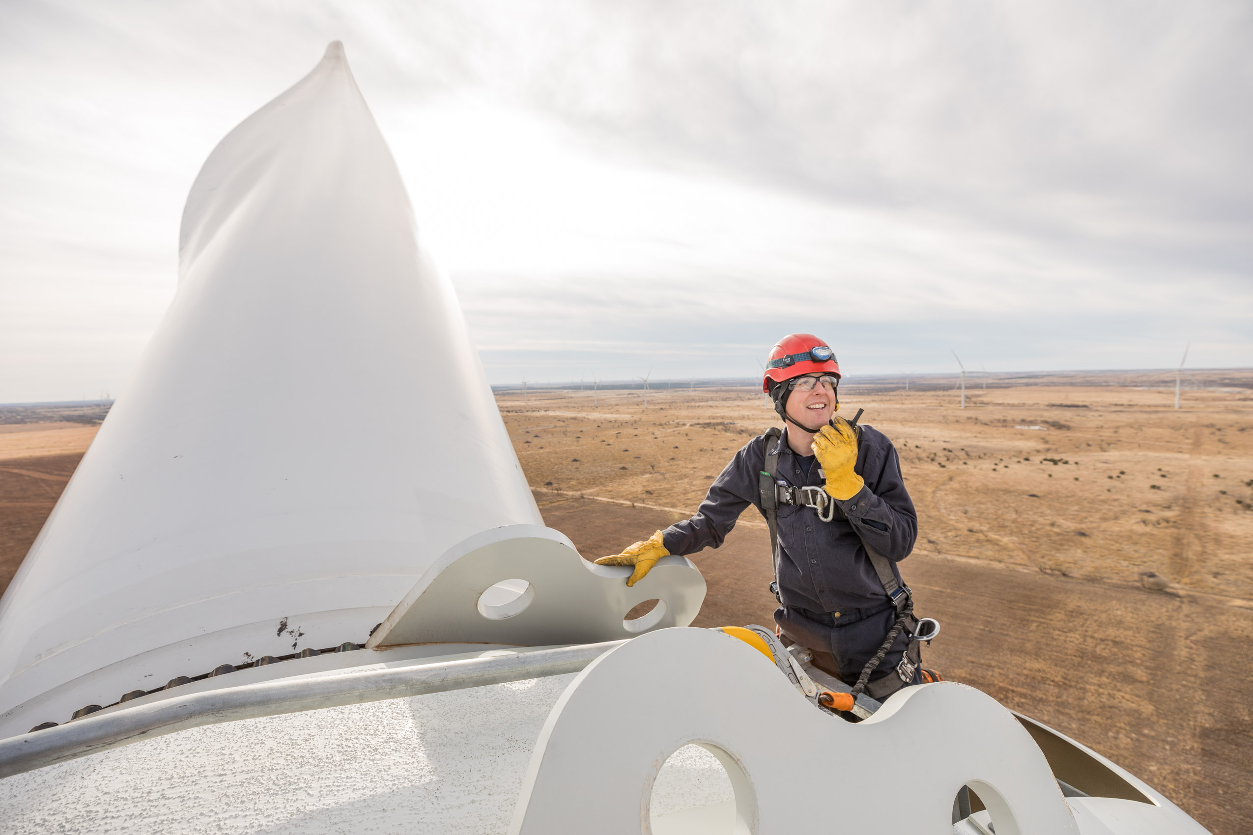 Wind turbine technician on clean renewable energy wind farm. nacelle view