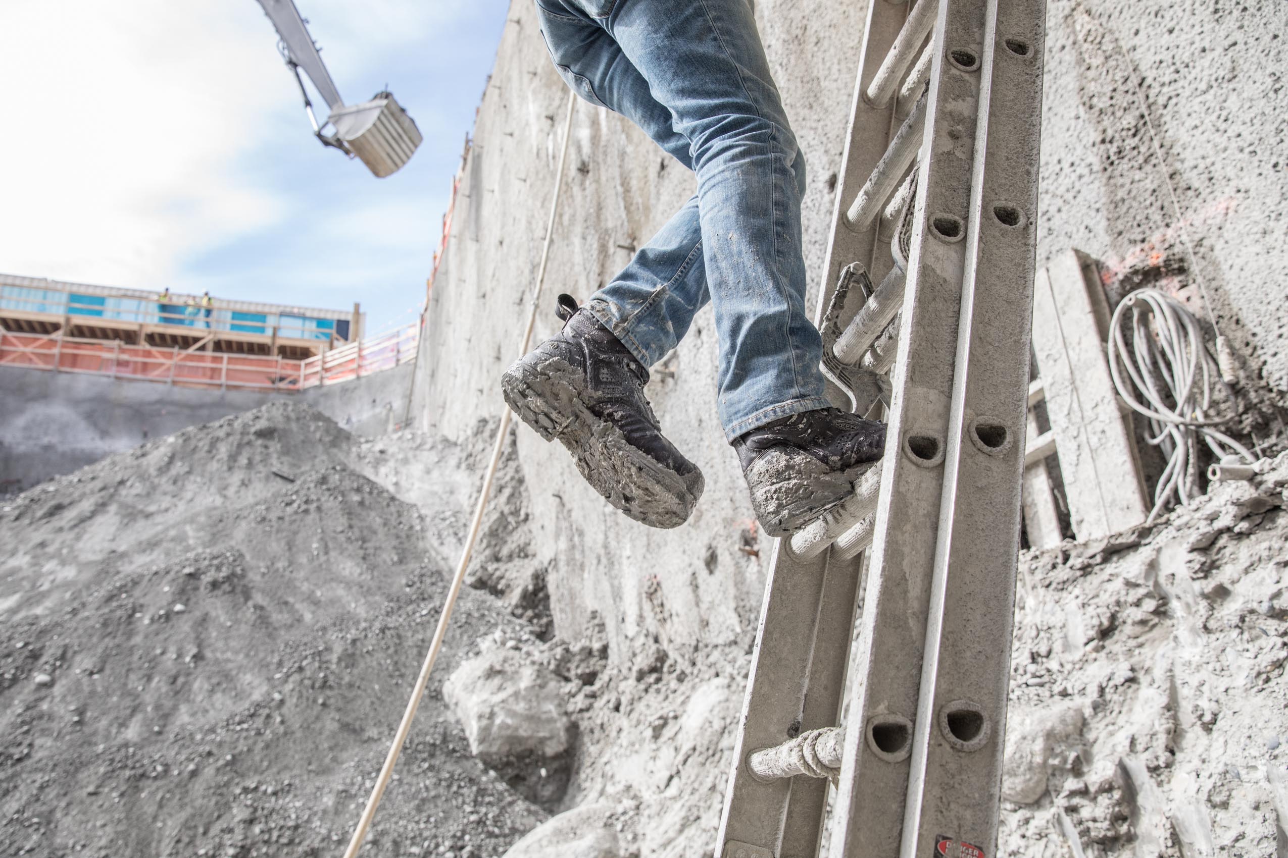 worker on ladder in pit