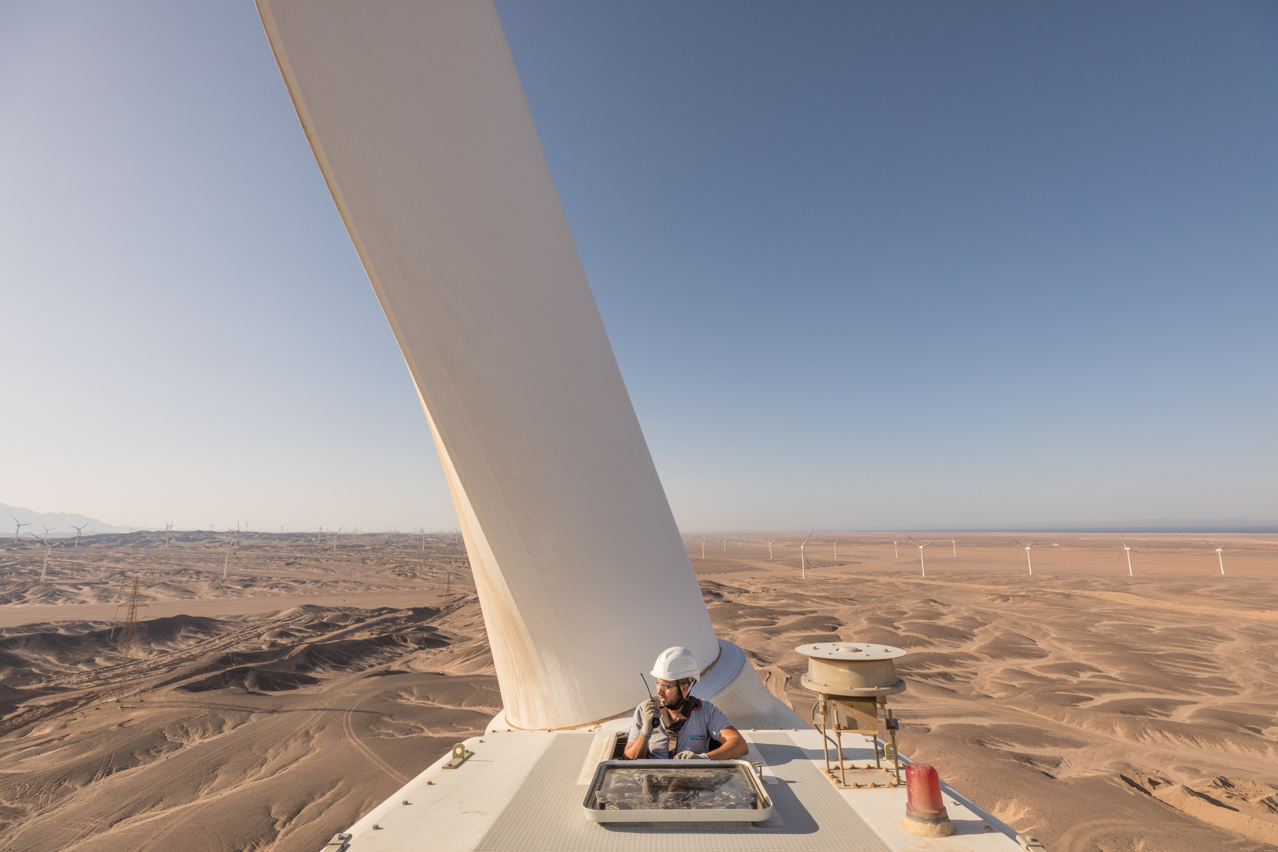 wind turbine farm with technicians on nacelle in the desert of Egypt, Africa with Siemens Gamesa renewable clean energy Photographer Rich Crowder