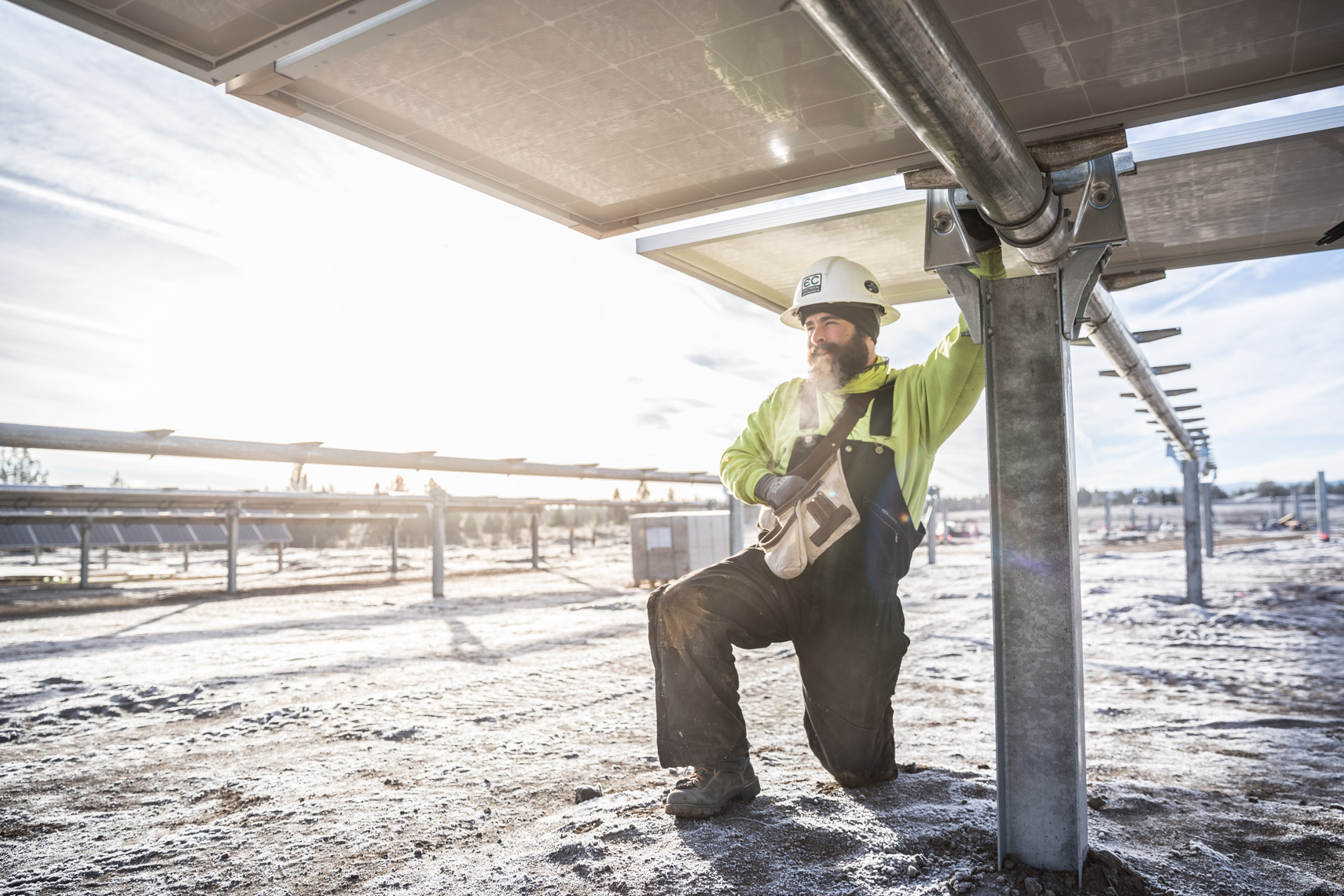 Renewable Solar panel farm worker installing by energy photographer Rich Crowder 