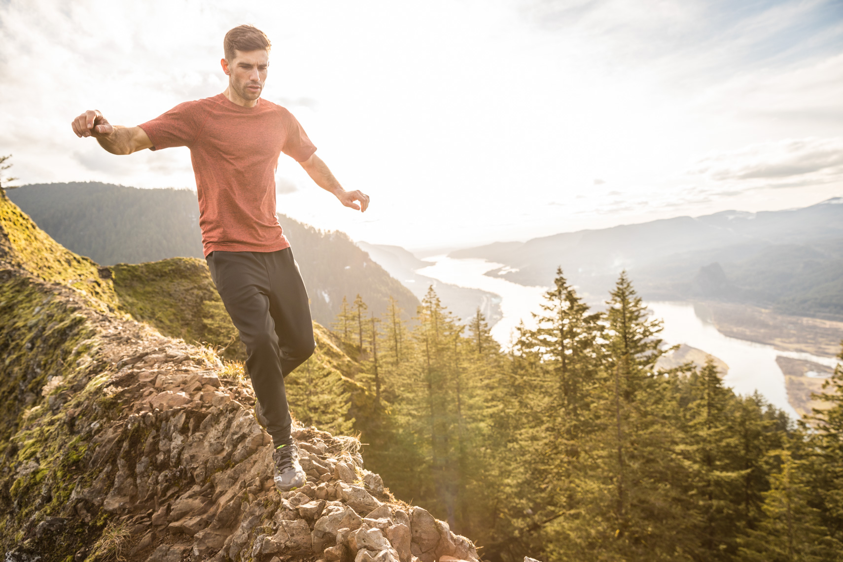 Mountain athlete runs on cliffs edge Photographer Rich Crowder